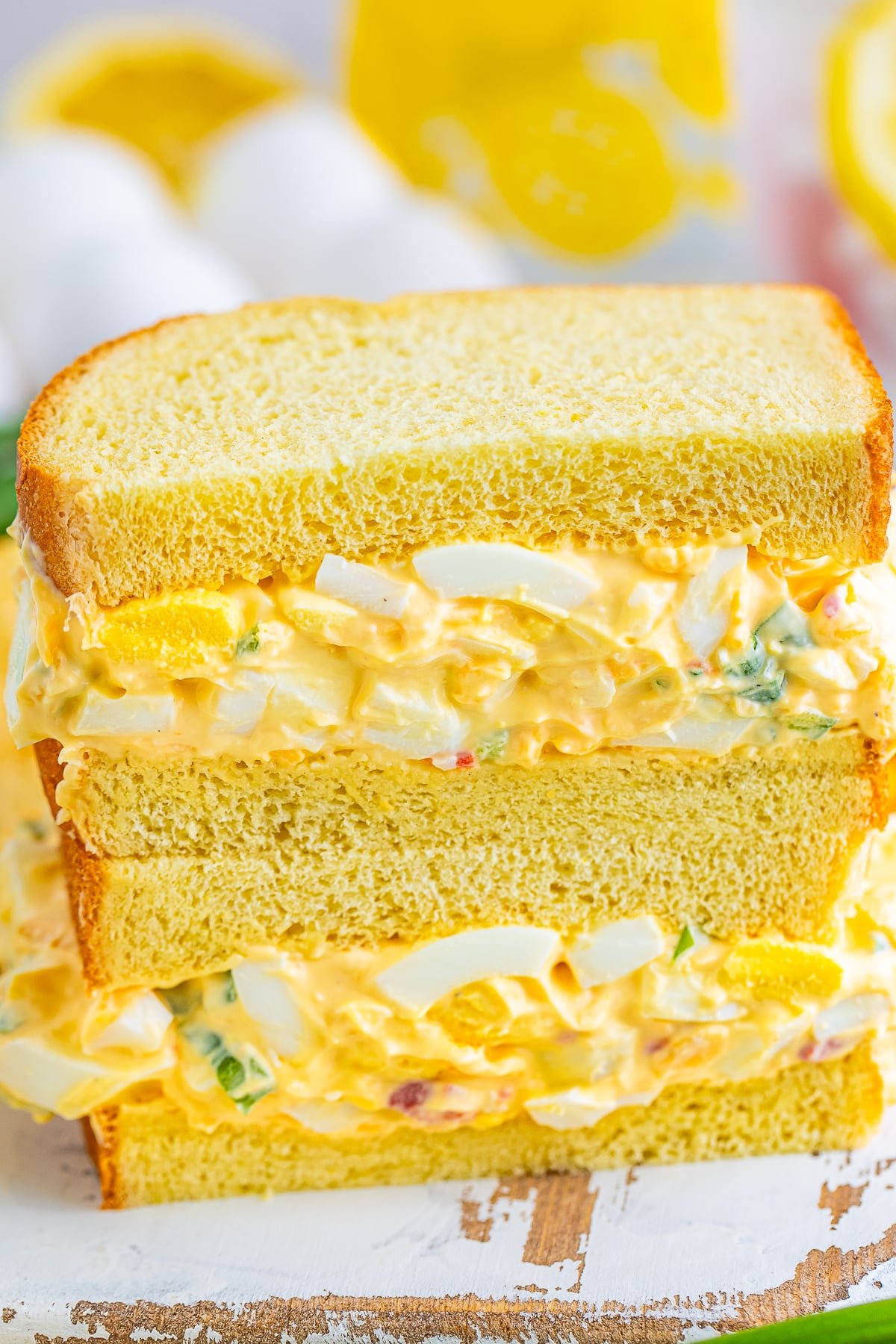 up close image of Egg Salad Sandwiches stacked on top of each other