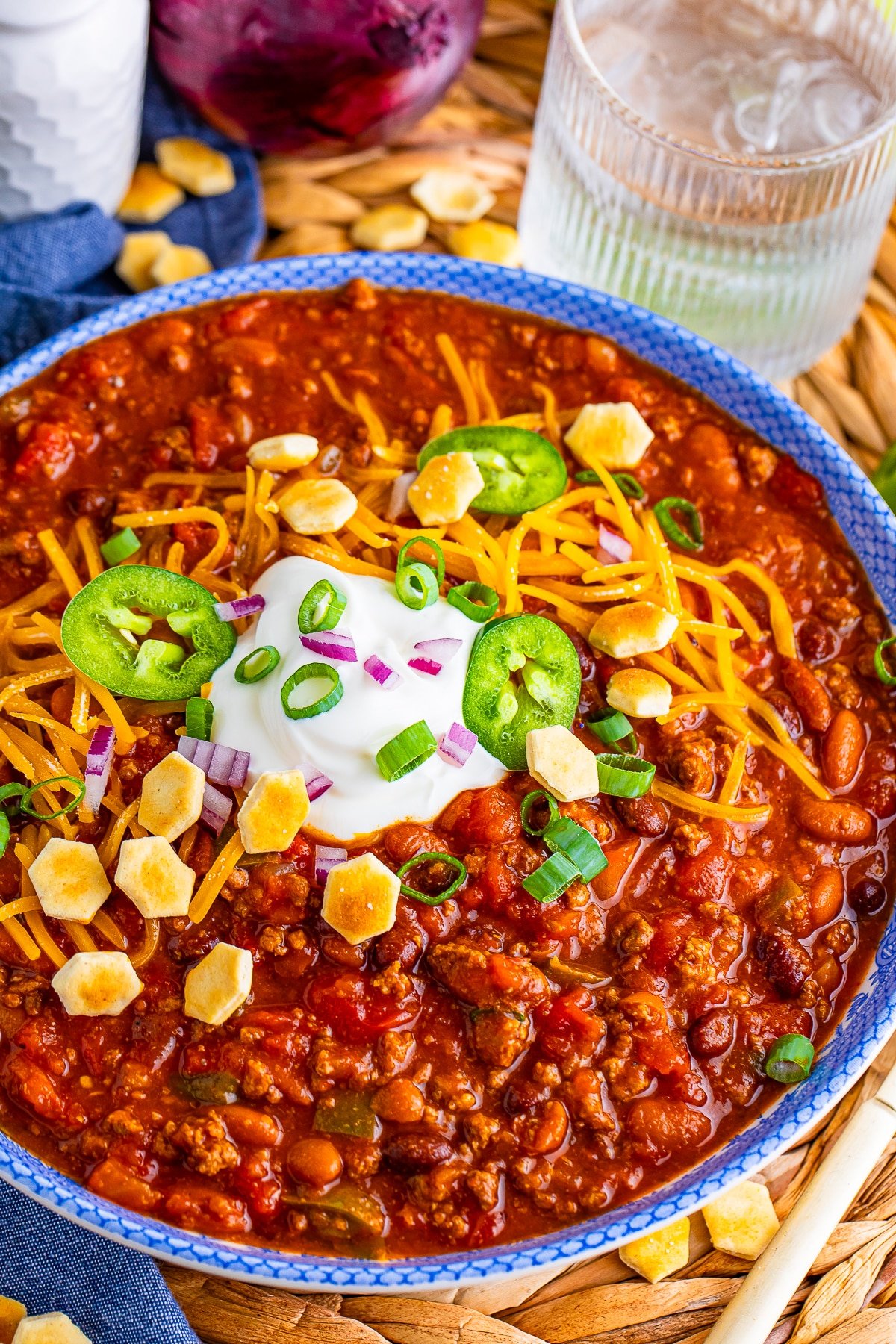 Award Winning Chili Recipe served in a blue bowl with toppings