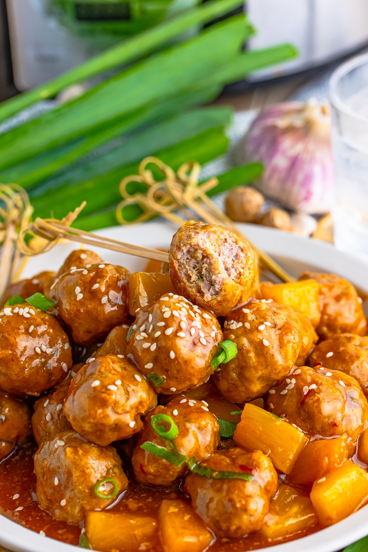 up close image of Pork Meatballs with  a bite taken out