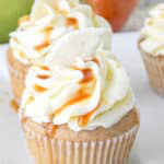 Apple Pie Cupcakes topped with buttercream, caramel drizzle, and a dried apple wedge.
