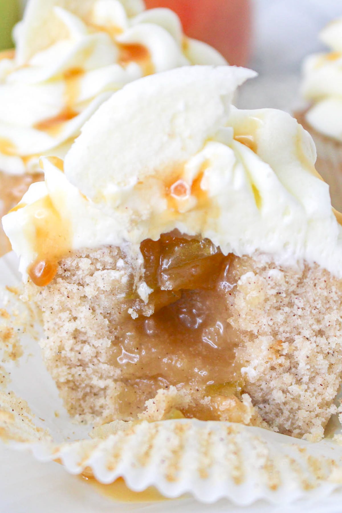 up close image of Apple Pie Cupcakes that has been cut in half to see the apple filling