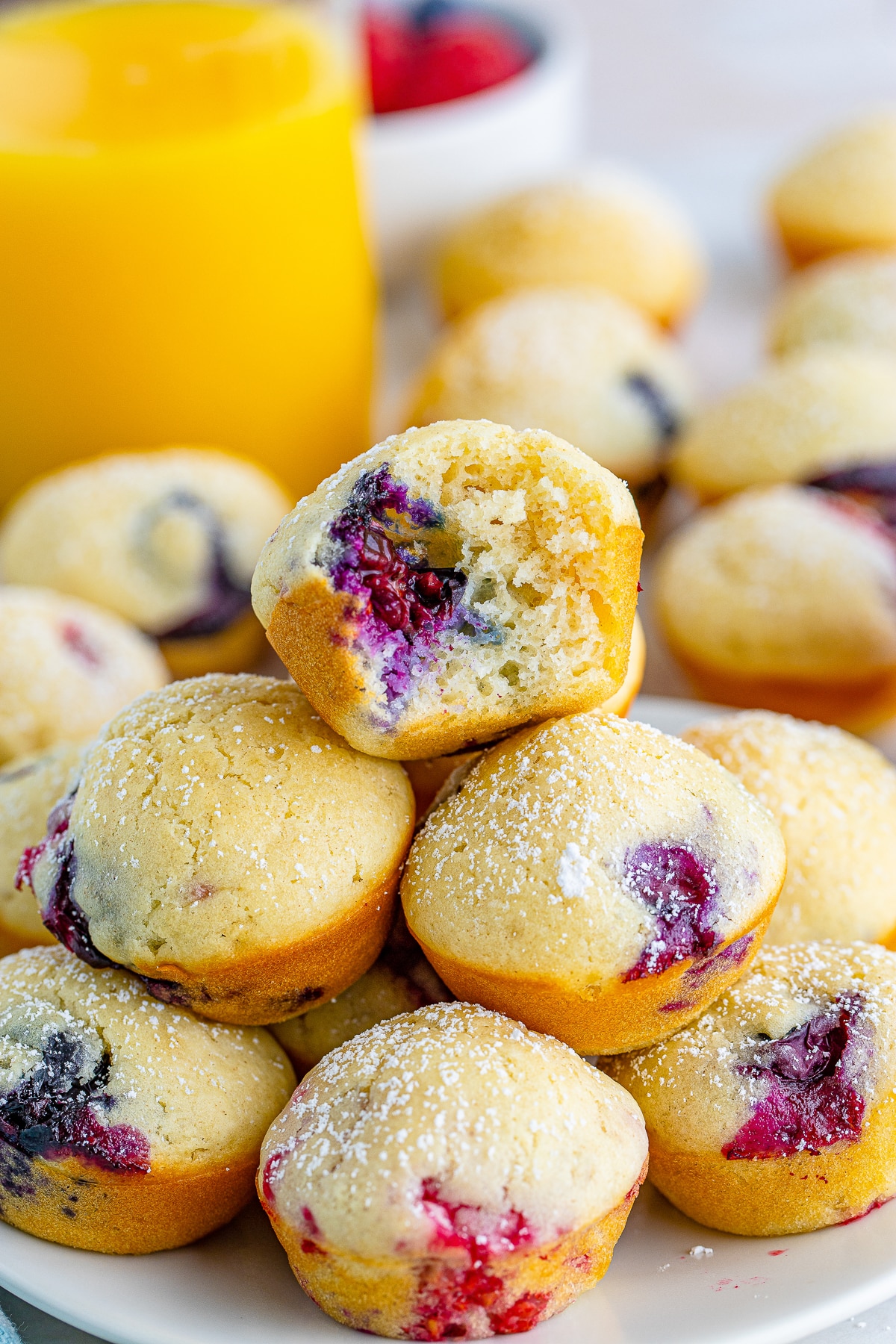 Pancake Bites stacked on a plate, the one on the top has a bite taken out