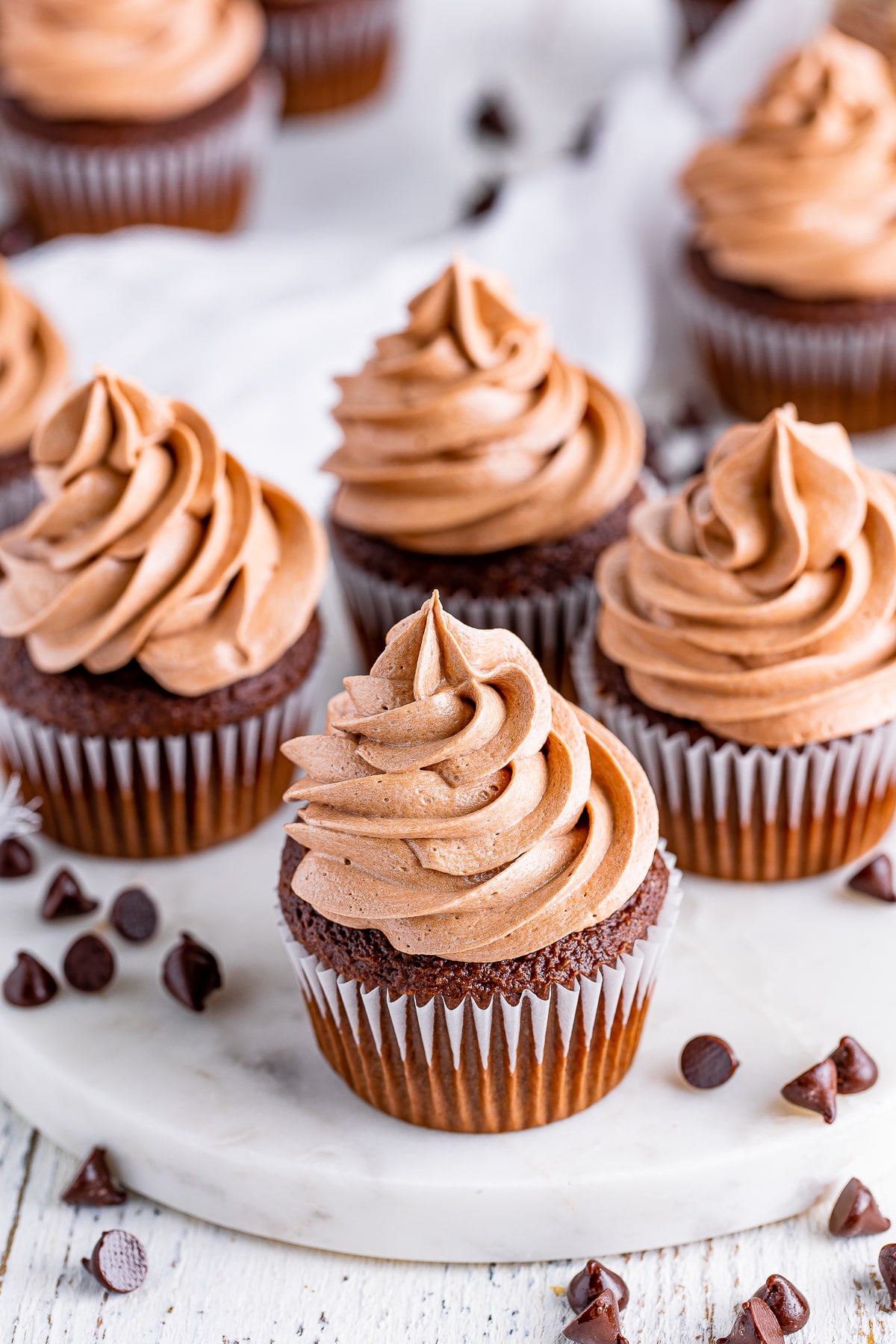 cupcakes frosted with Chocolate Cream Cheese Frosting on a white marble board
