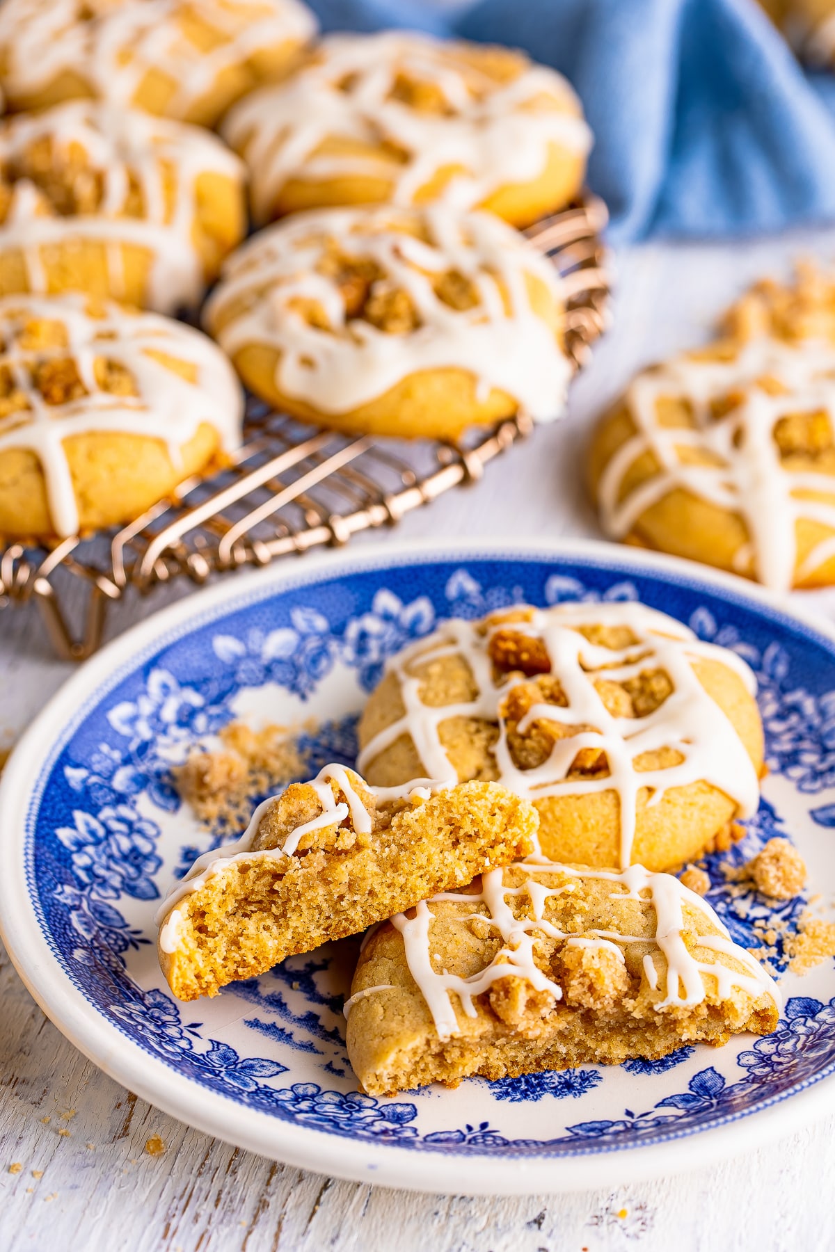 Coffee Cake Cookies on a blue plate, one cookie is broken in half to see the interior