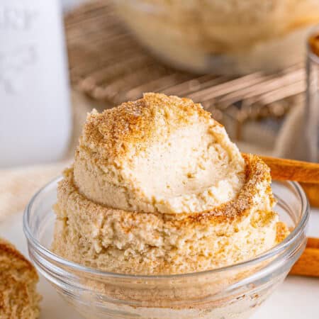 A glass bowl of edible Snickerdoodle Cookie Dough topped with cinnamon sugar.