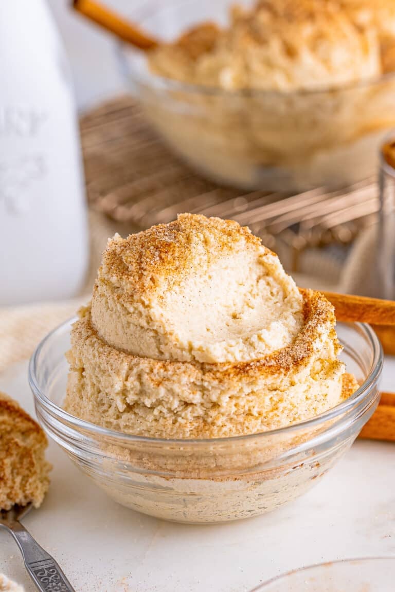 A glass bowl of edible Snickerdoodle Cookie Dough topped with cinnamon sugar.