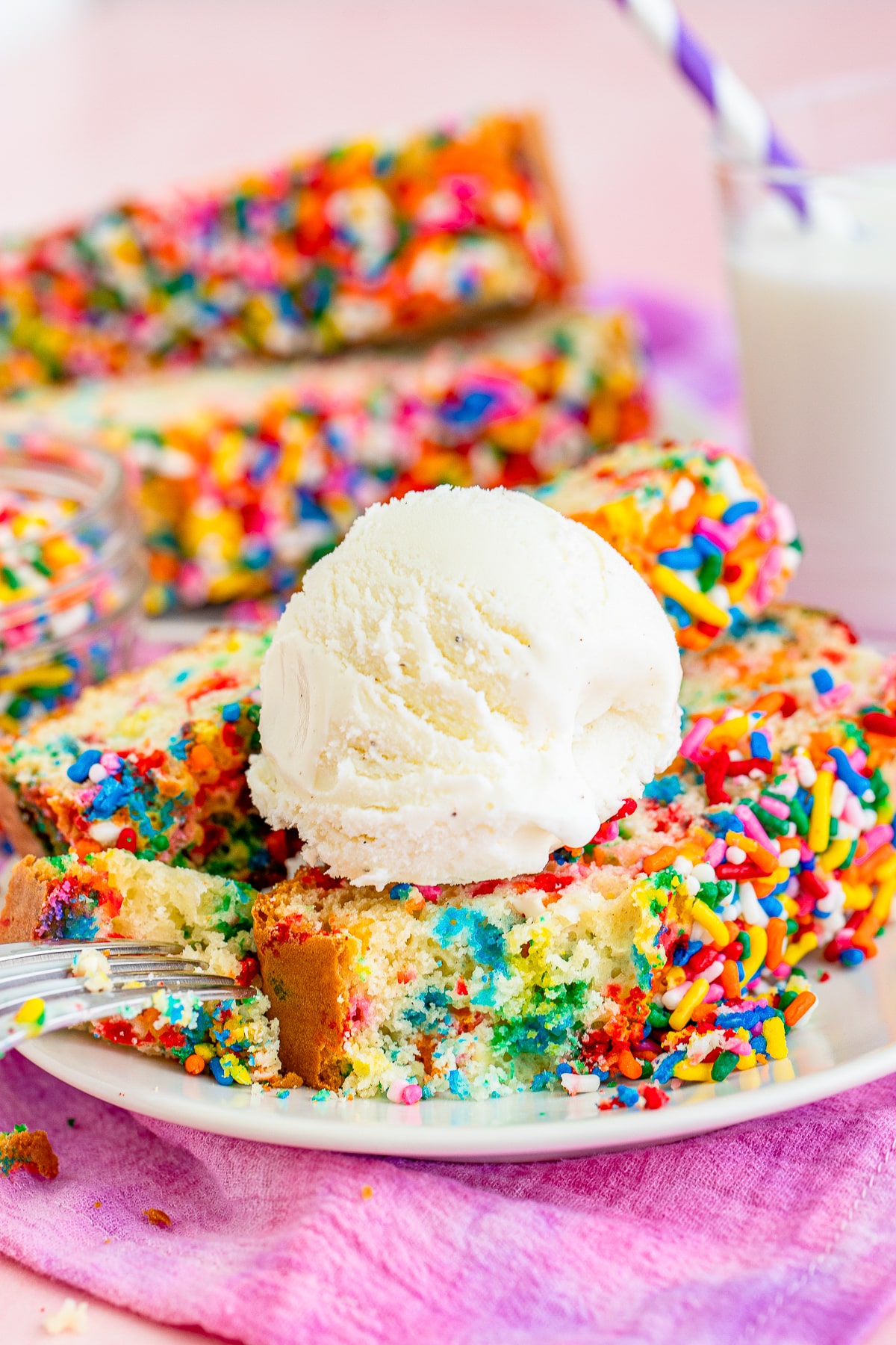 a slice of Ice Cream Bread on a plate with a scoop of ice cream on top with a bite taken out