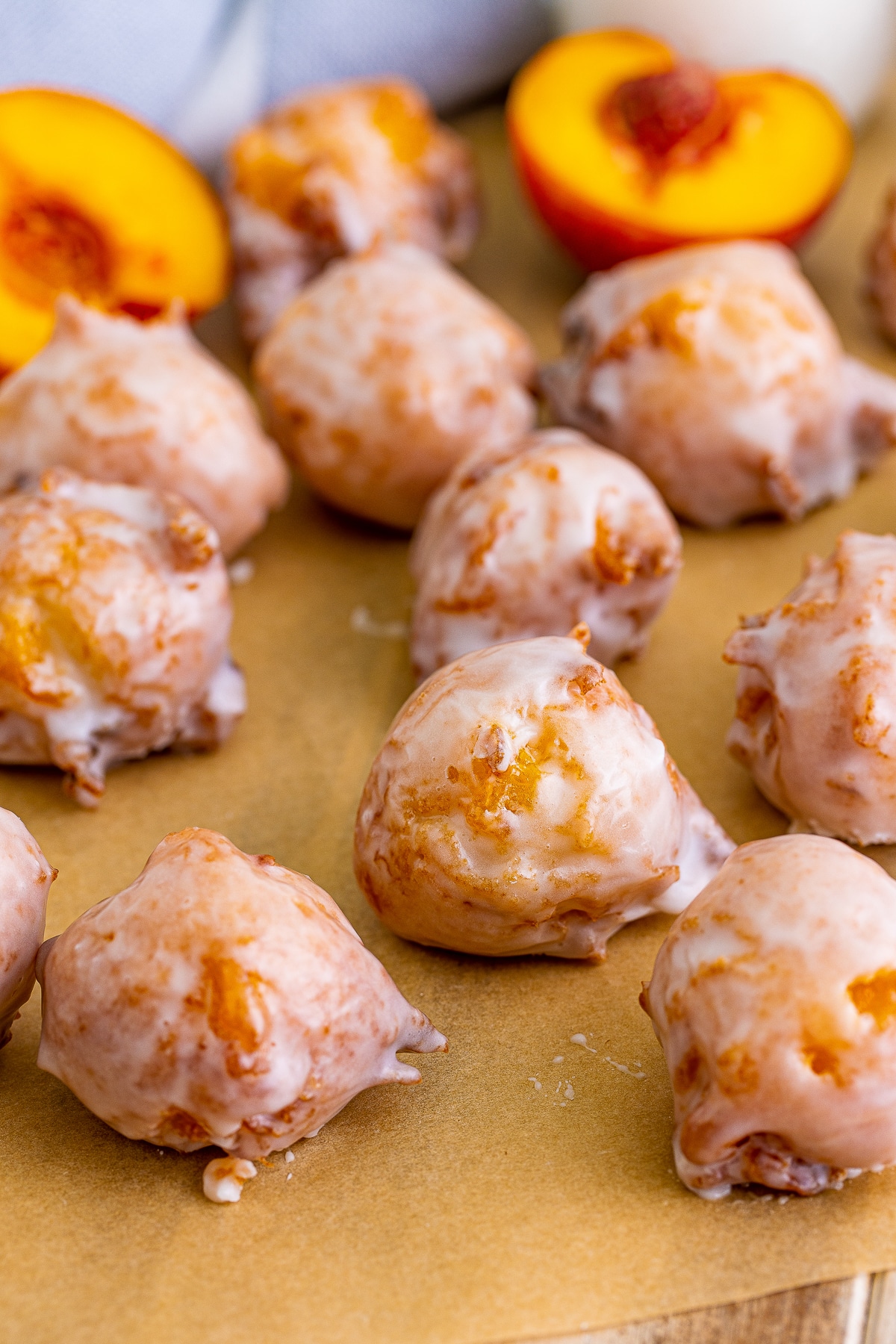 Peach Fritters glazed layying on brown parchment paper