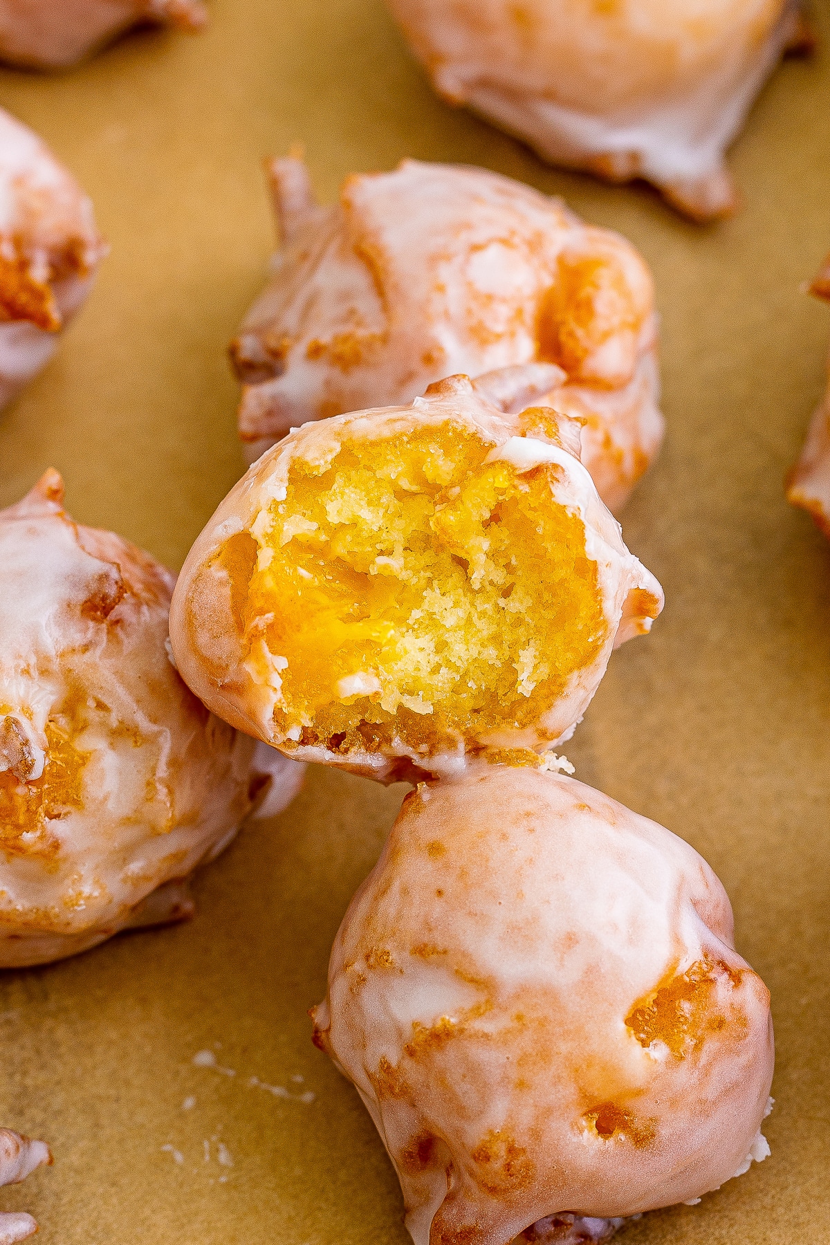 Peach Fritters stacked on top of each other, the top one with a bite taken out