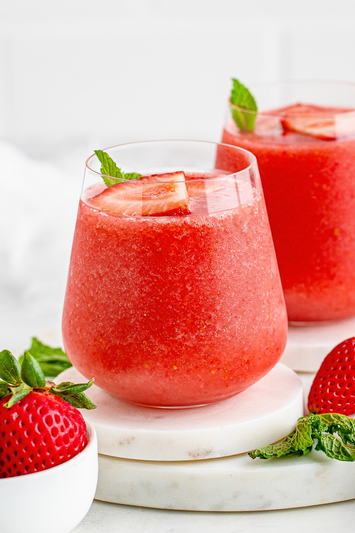 straight on image of Wine Slushies in wine glasses on white marble