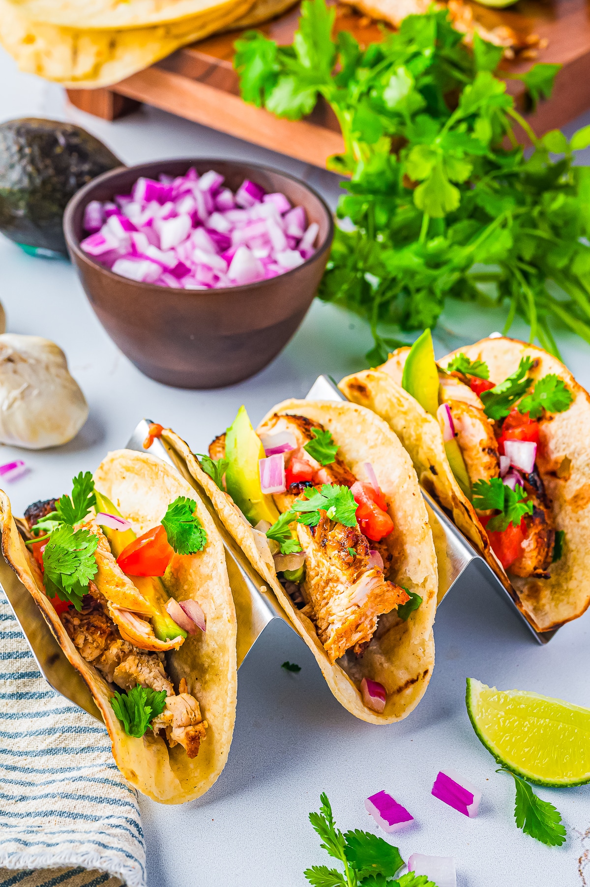 finished Chicken Tacos in a taco tray with toppings