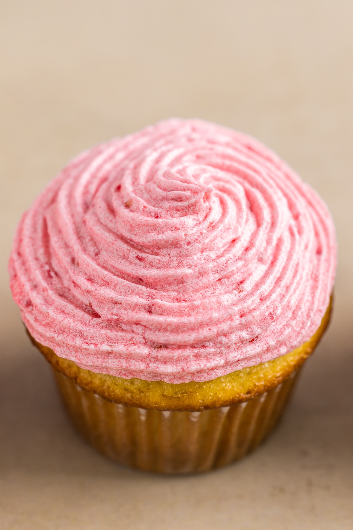 a cupcake topped with Raspberry Frosting
