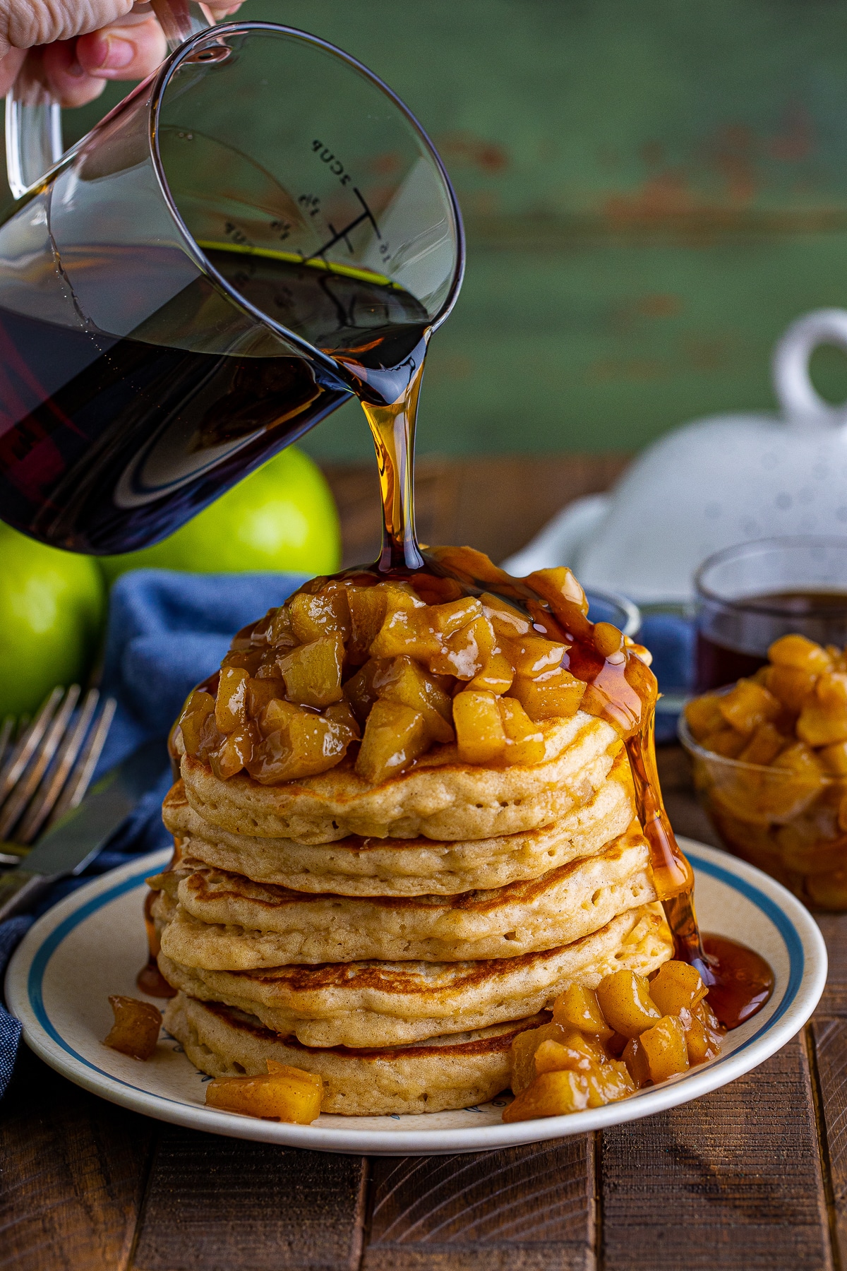 maple syrup being poured over our Apple Pancakes Recipe