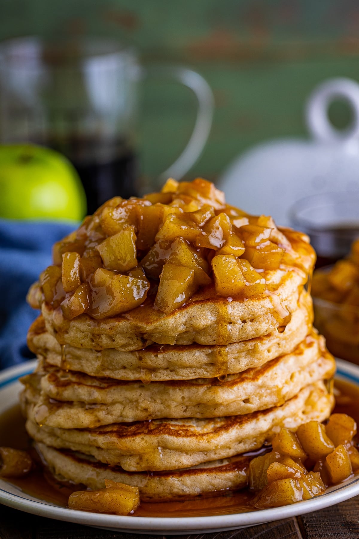 Apple Pancakes Recipe piled high on a tan plate