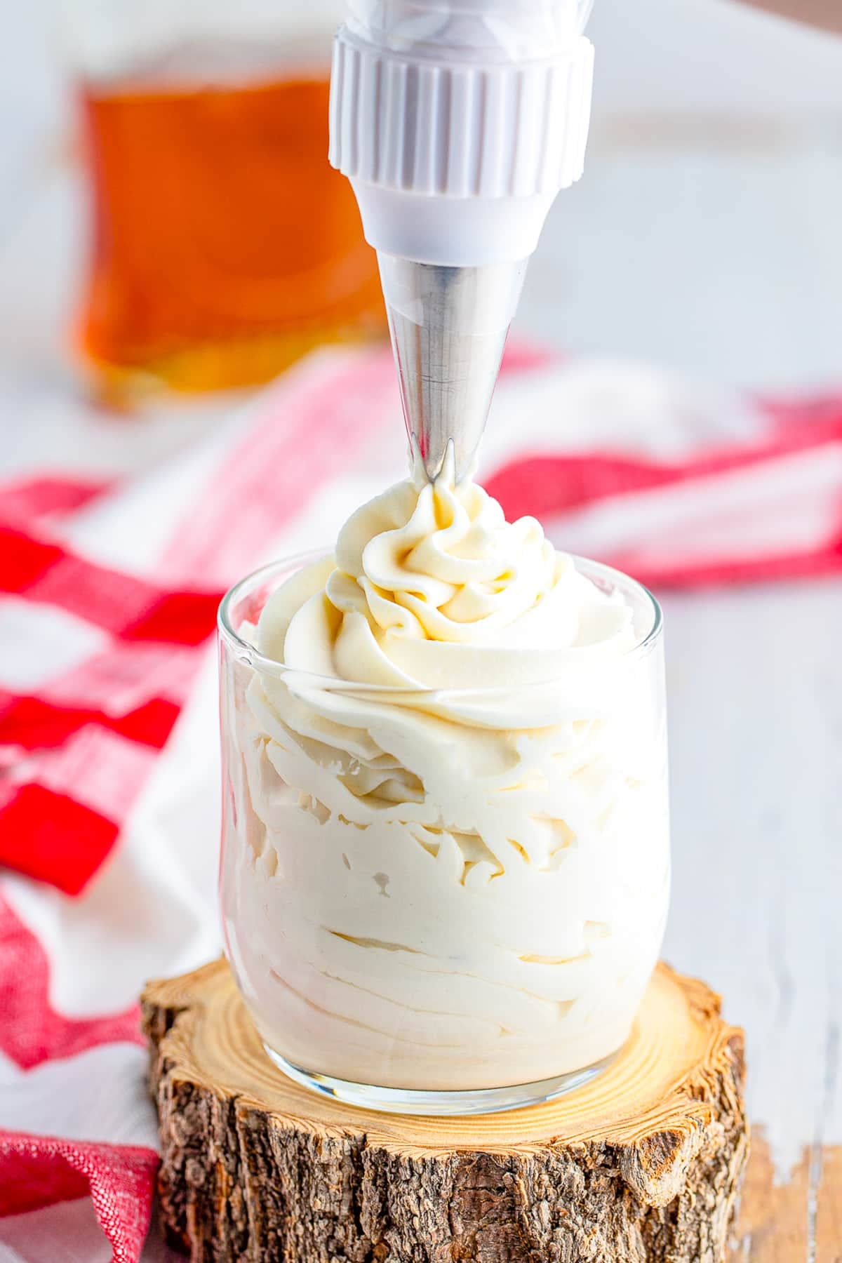 a piping bag adding Maple Whipped Cream to a glass