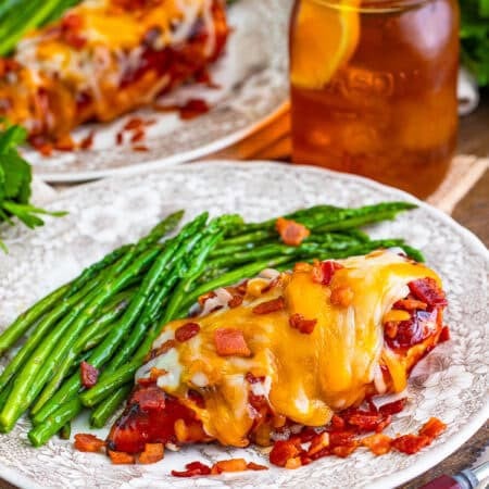 Copycat Chili's Monterey chicken topped with bacon and melted cheese on a plate.