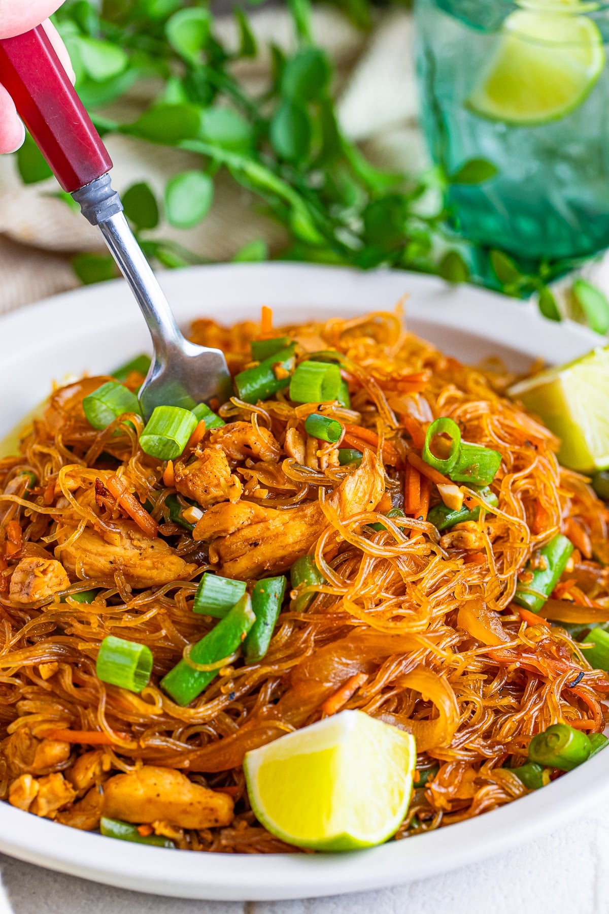 a fork grabbing a bite of Pancit off the plate