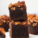Two Pecan Pie Brownies stacked showing the gooey maple pecan topping over the fudgy brownie base.