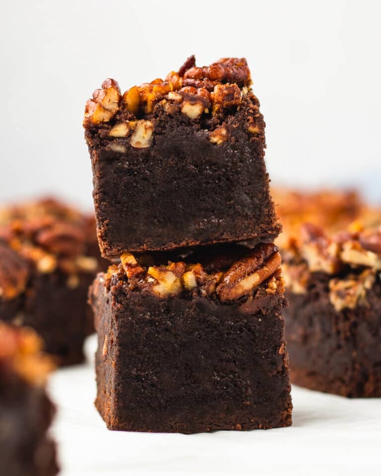 Two Pecan Pie Brownies stacked showing the gooey maple pecan topping over the fudgy brownie base.