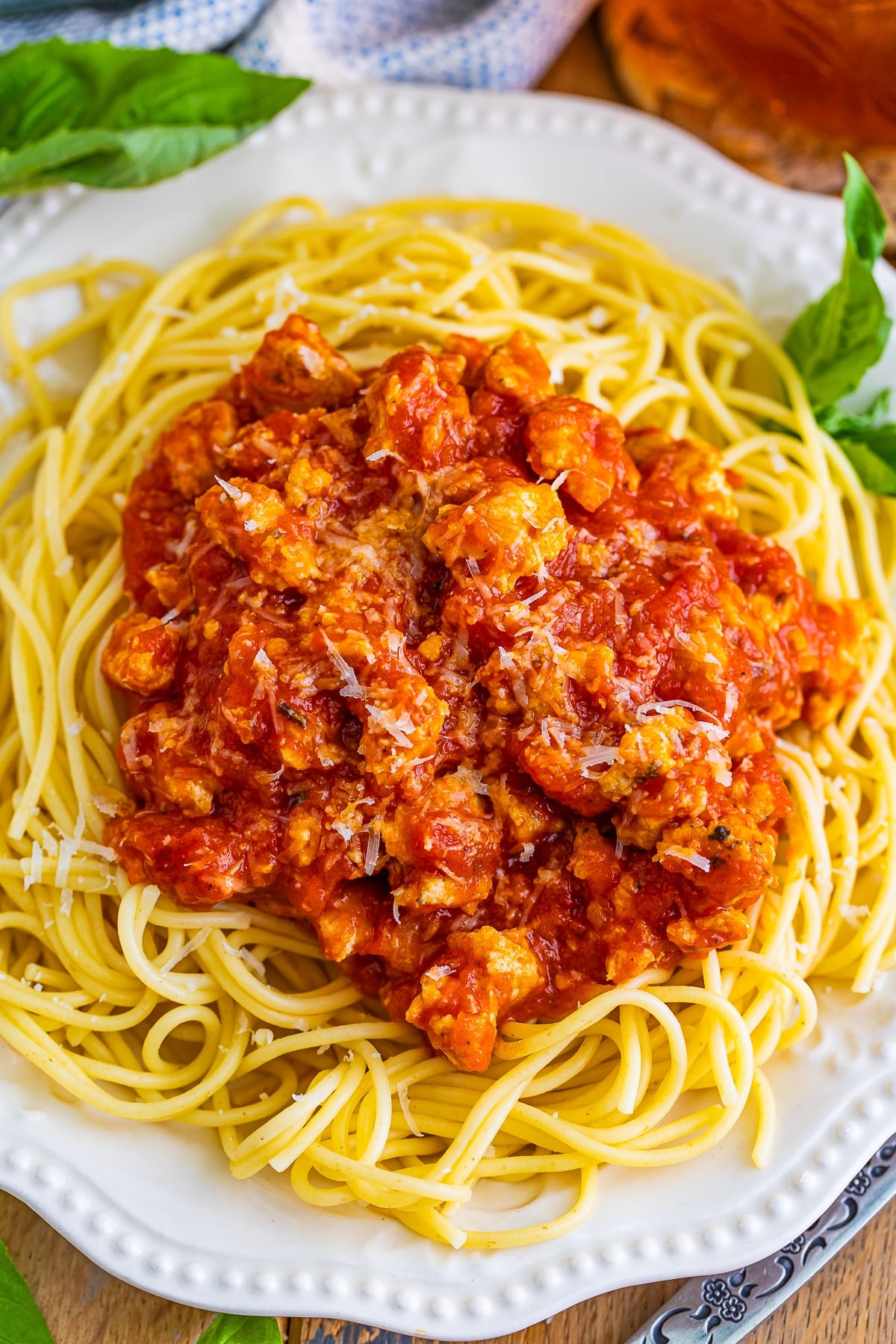 Meat Sauce made with easy homemade ground turkey sausage and bottled sauce makes this recipe easy, fast, and full of flavor. #recipe from thissillygirlskitchen.com #meatsauce #meatsaucewithturkey #spaghetti #marinara overhead image of Turkey Spaghetti on a white plate