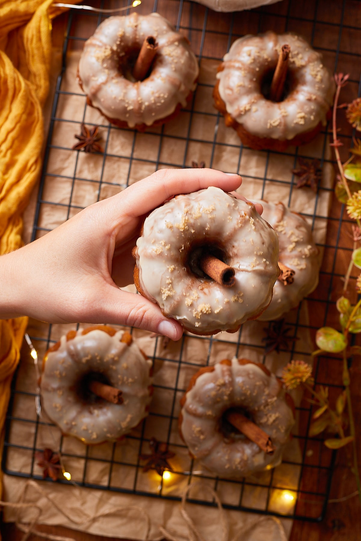 overhead image of a hand holding up Mini Bundt Cakes in air