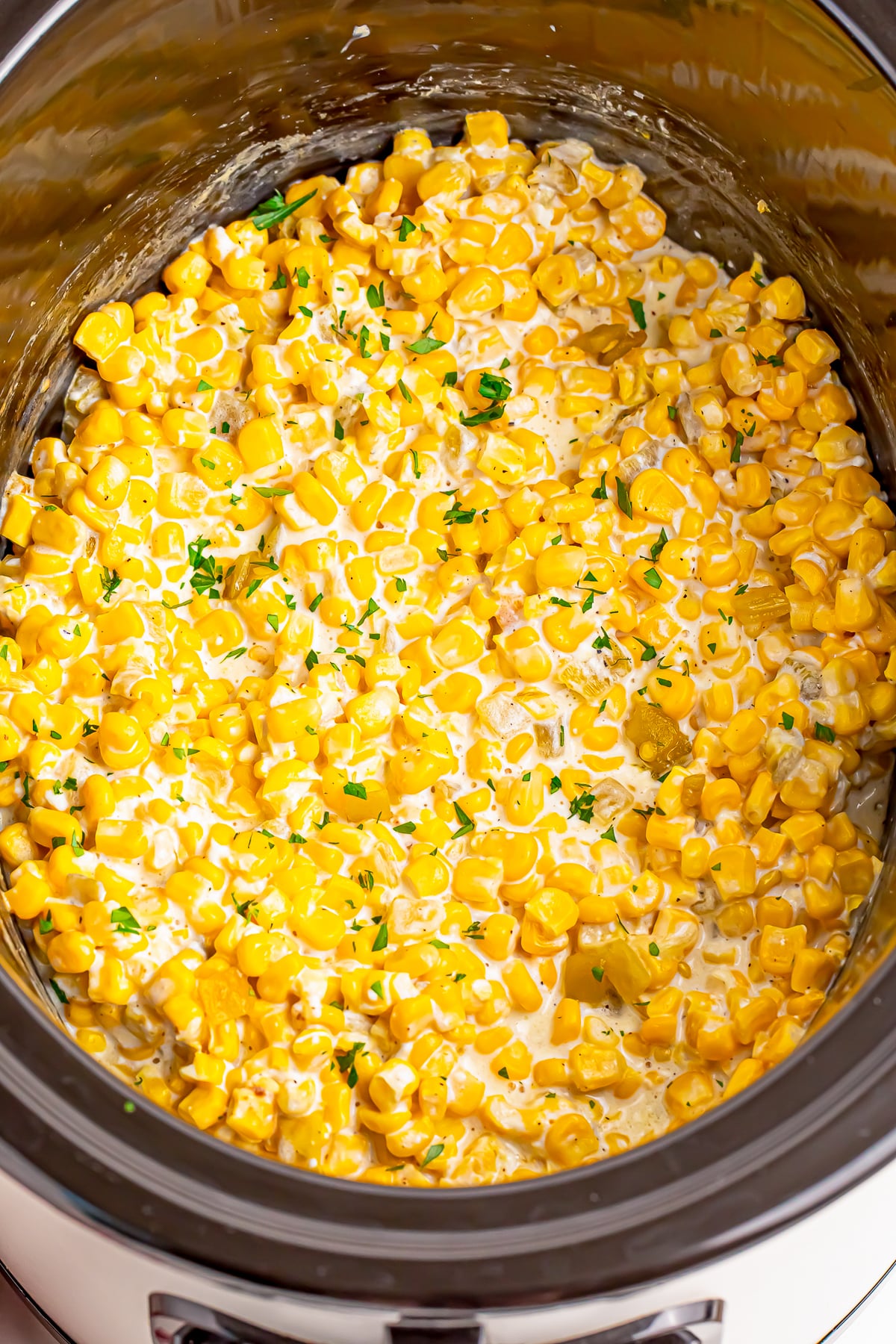 finished Slow Cooker Creamed Corn in slow cooker overhead image