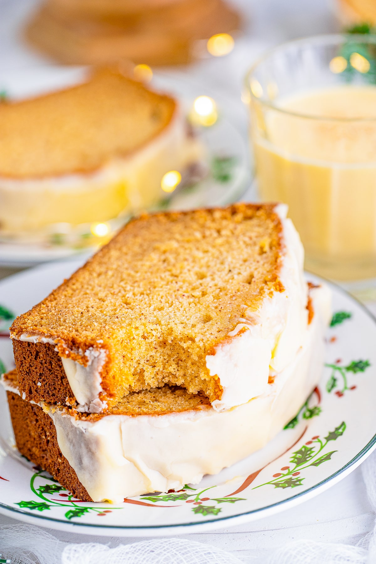 two slices of Eggnog Bread stacked on top of each other, the one on top has a bite taken out