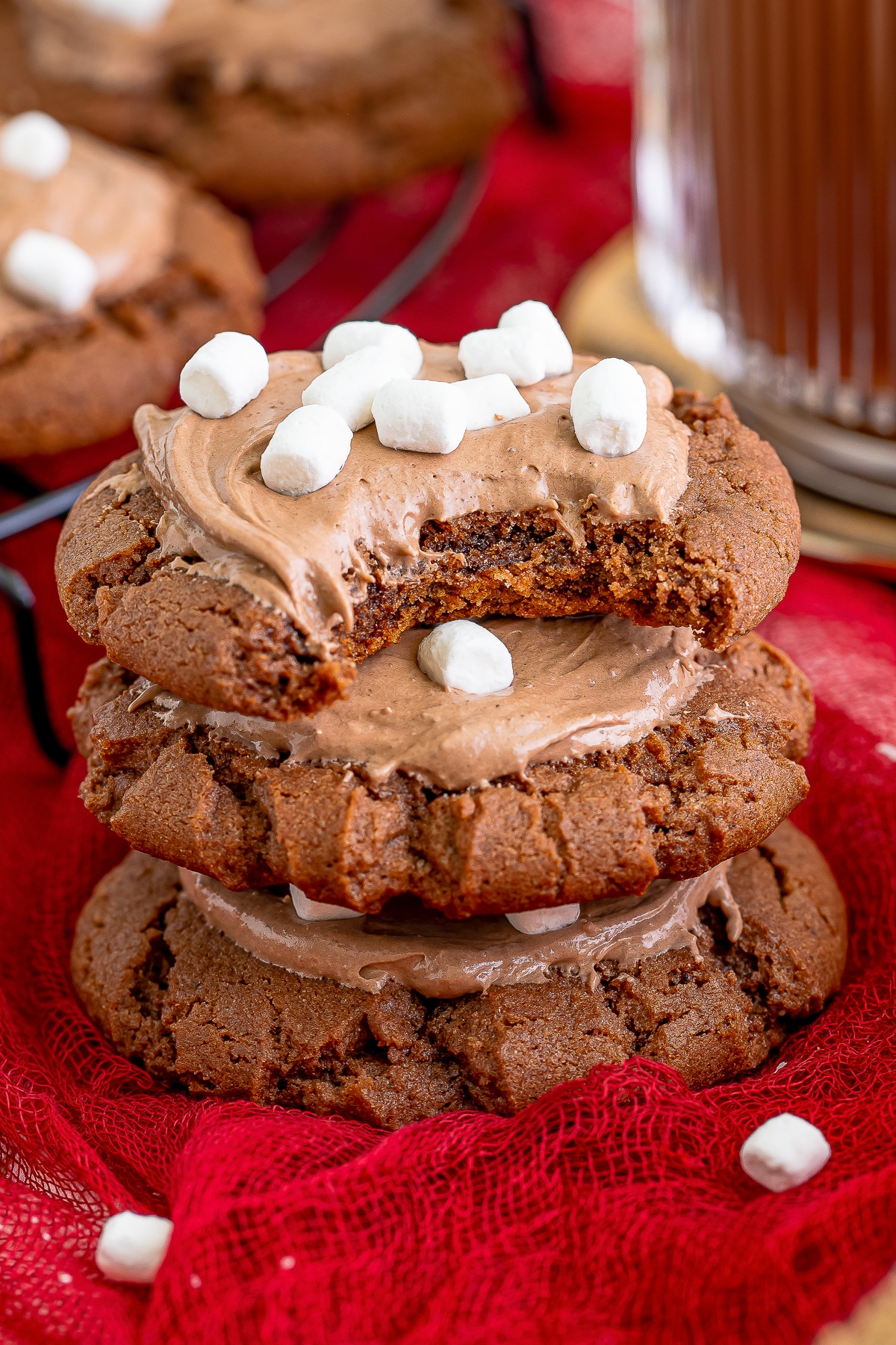 three Hot Chocolate Cookies stacked on top of each other, the one on top has a bite taken out