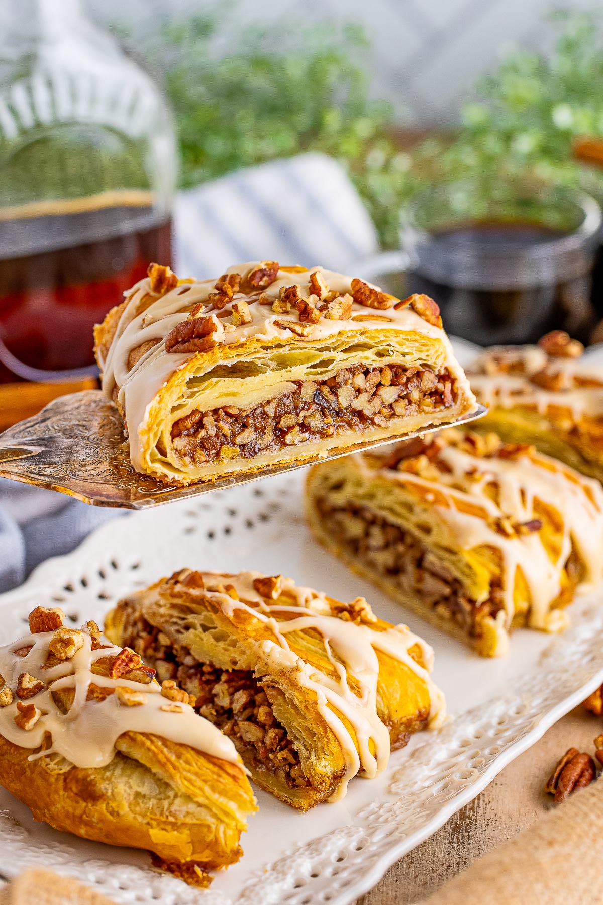 a cake server holding up a slice of Pecan Pastry in air