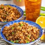 Easy Sausage Rice Recipe (Cajun Dirty Rice) in a skillet with seasoned ground sausage, rice, and scallion garnish.