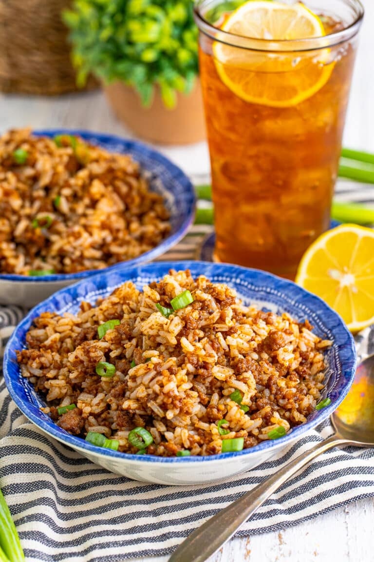 Easy Sausage Rice Recipe (Cajun Dirty Rice) in a skillet with seasoned ground sausage, rice, and scallion garnish.