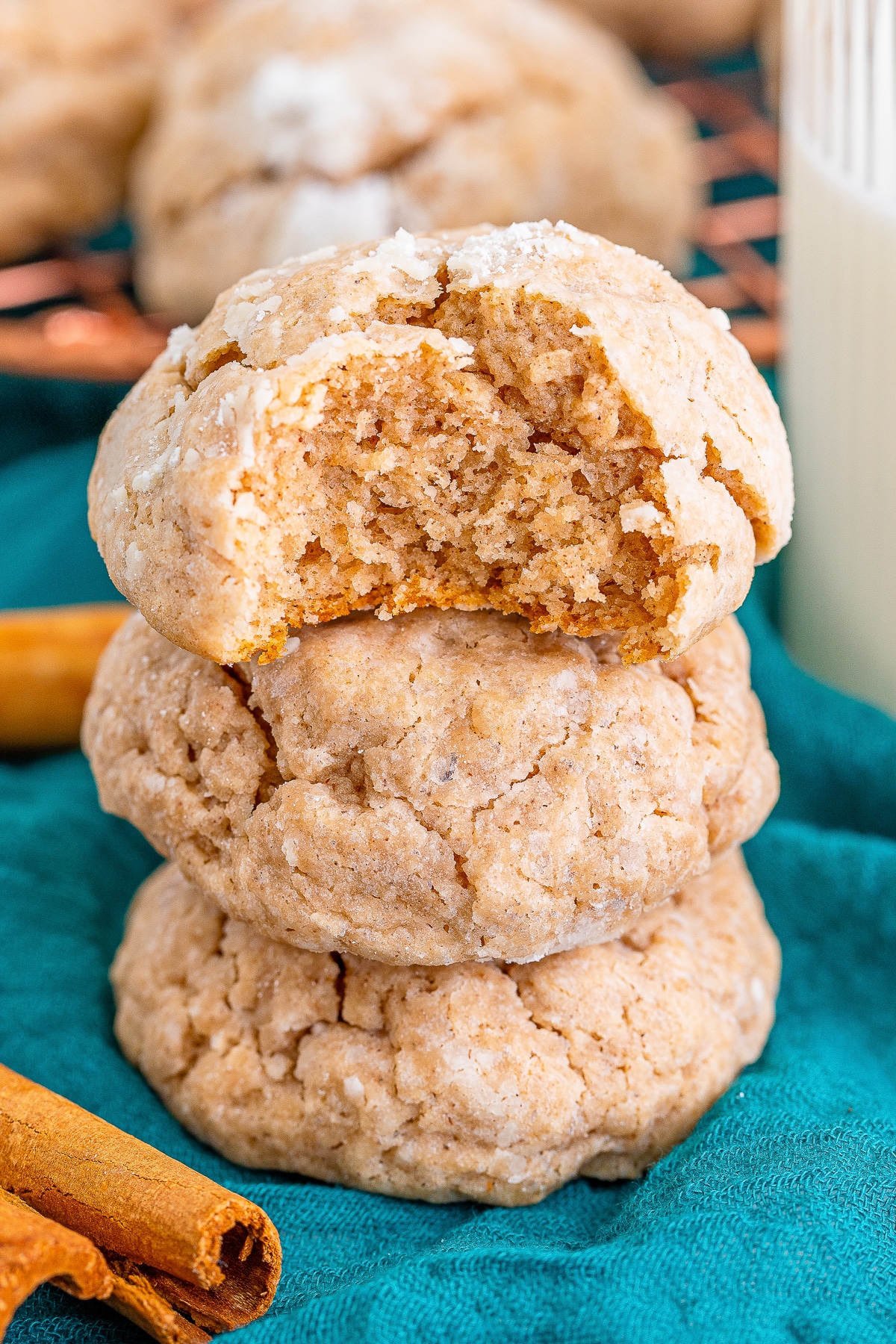 a stack of three Gooey Butter Cookies the top one has a bite taken out to show interior