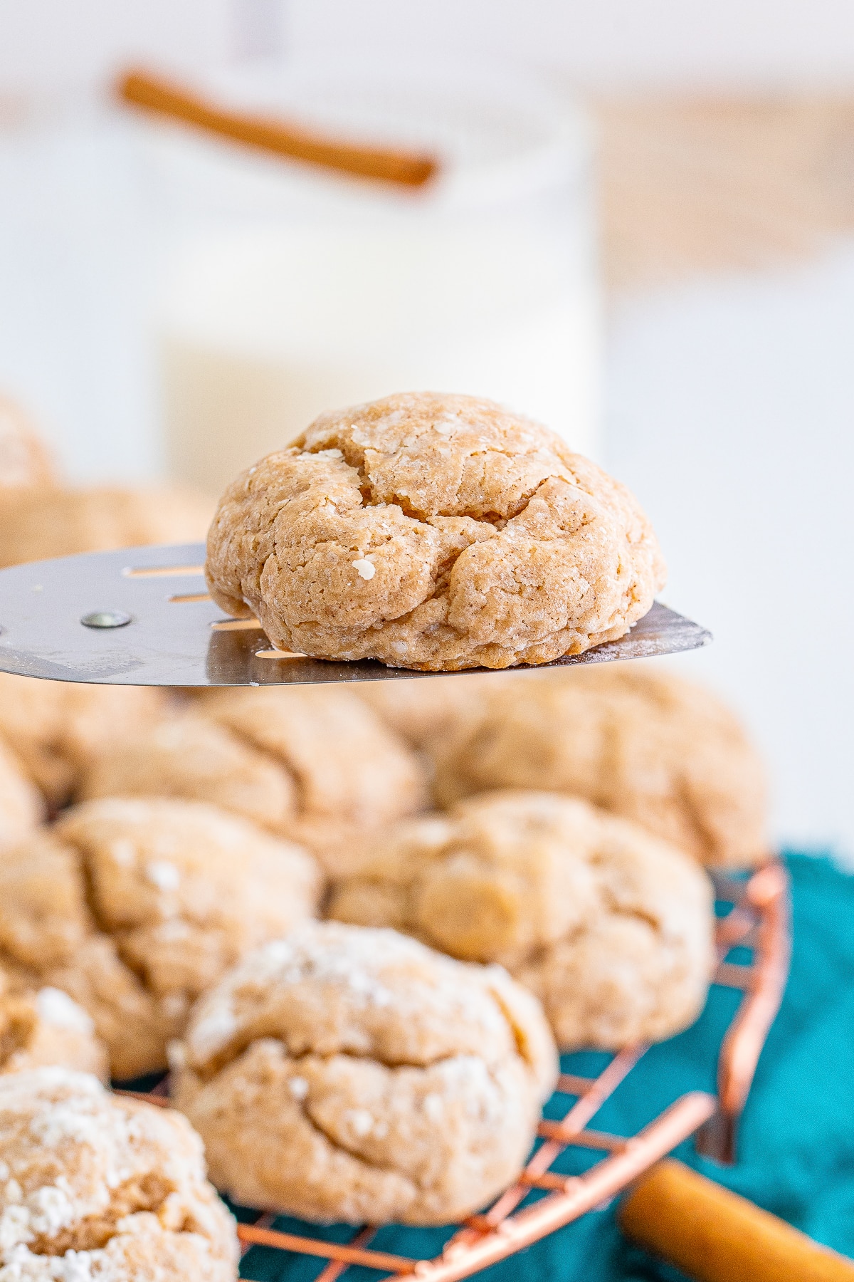 a spatula holding up Gooey Butter Cookies in air