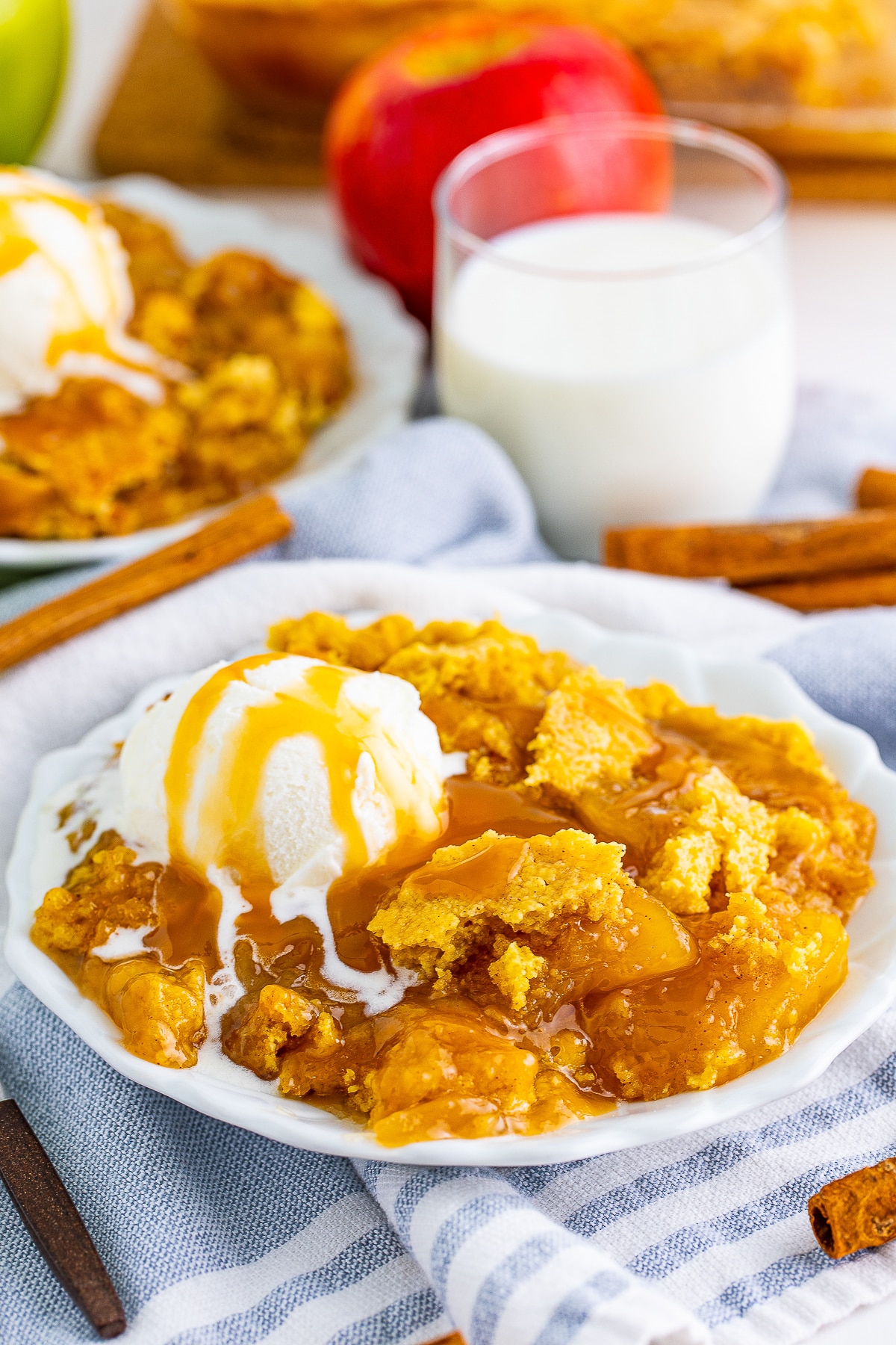 Caramel Apple Dump Cake served on a white plate with ice cream