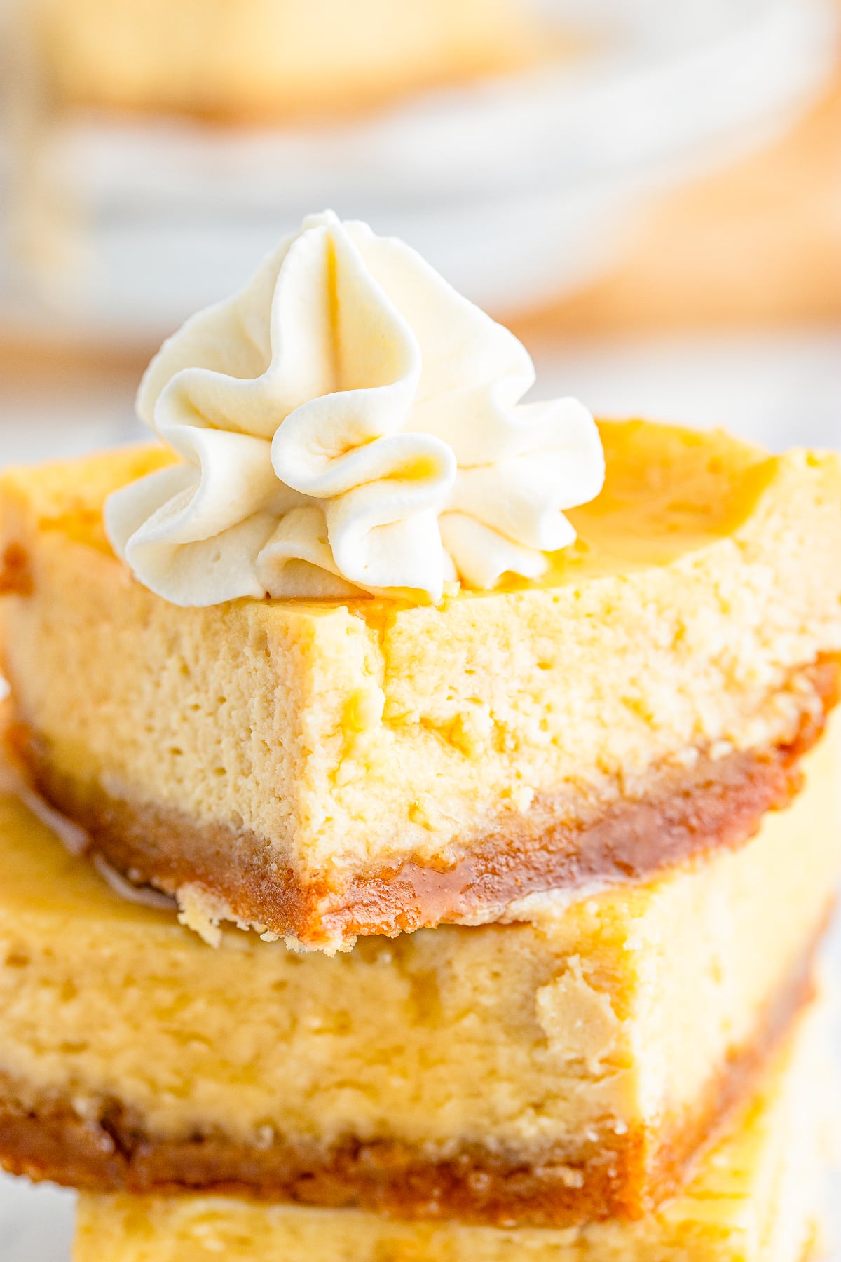 up close image of Maple Cheesecake pieces stacked on top of each other with whipped cream