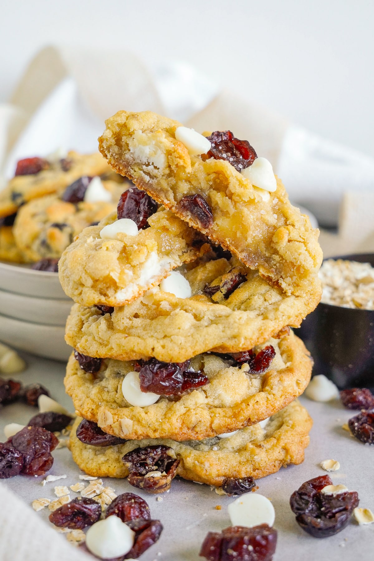 a stack of White Chocolate Cranberry Cookies with one on top cut in half