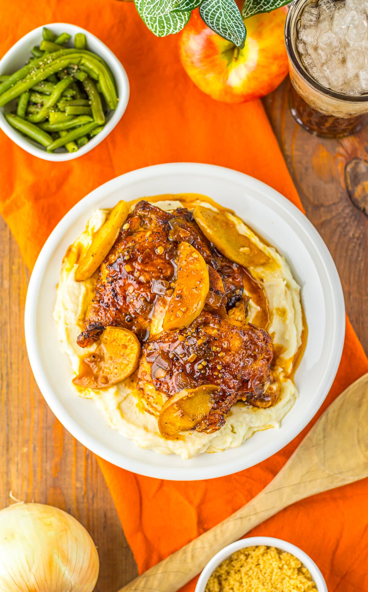 overhead image of a plate of Apple Cider Chicken on wooden table top