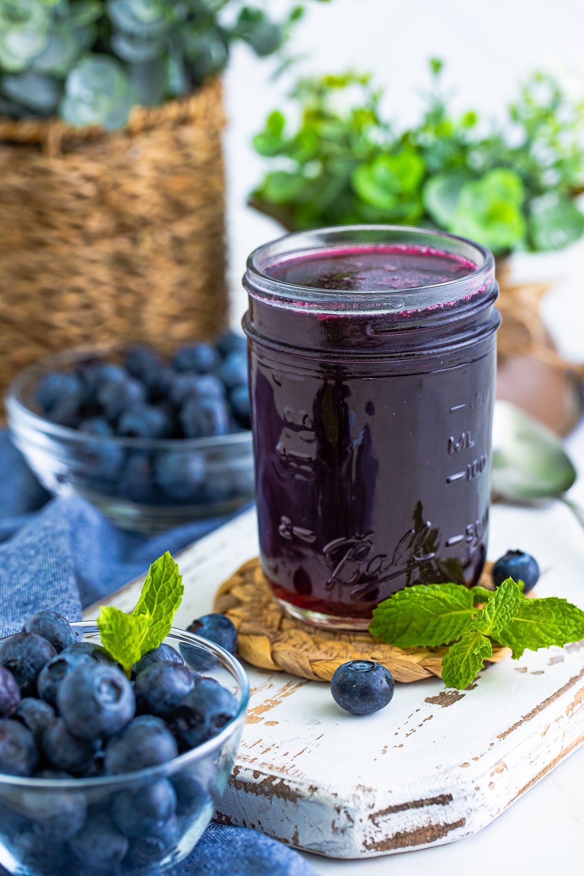 Blueberry Syrup in a mason jar with lots of blueberries