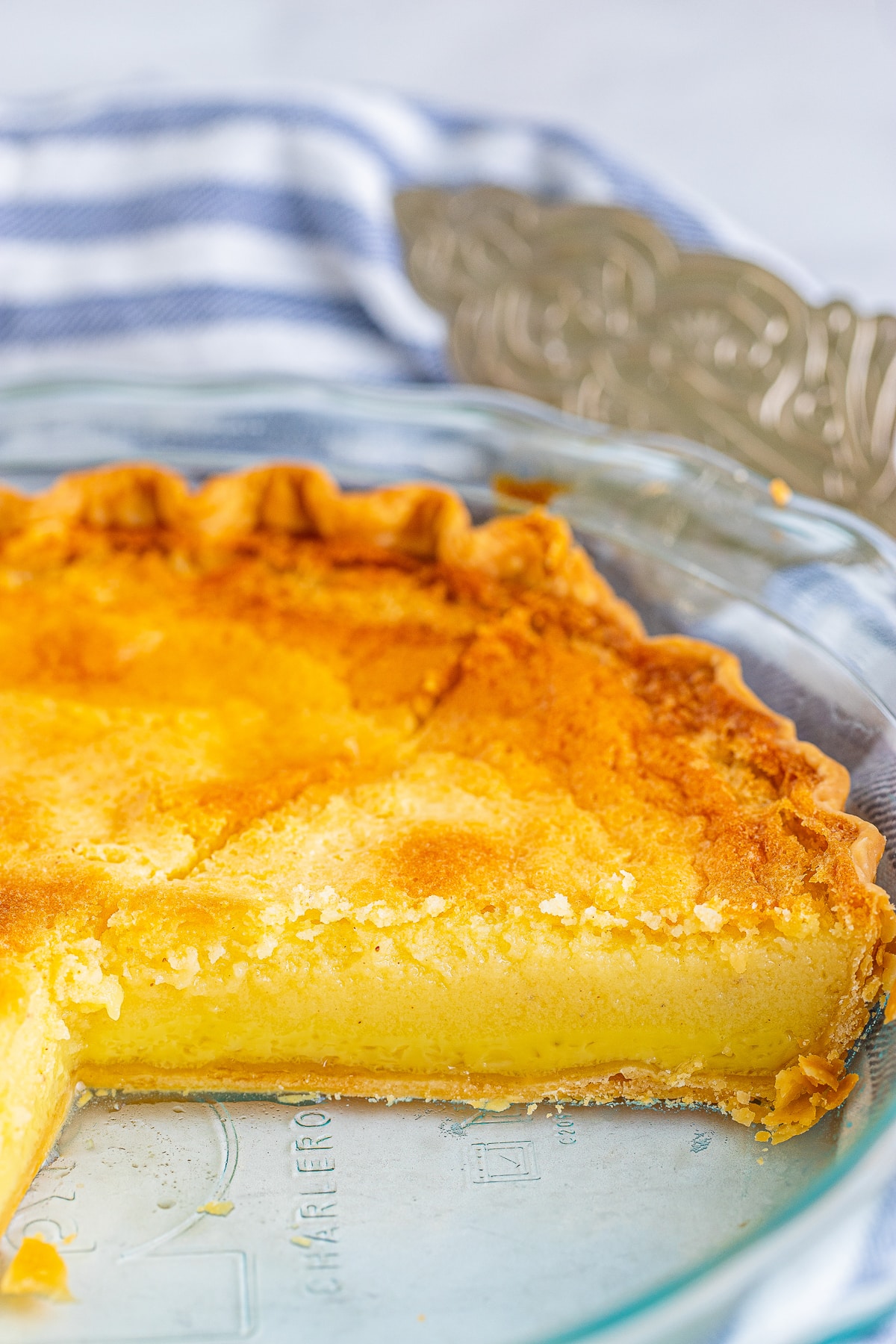 Buttermilk Pie in a pie plate with a slice taken out