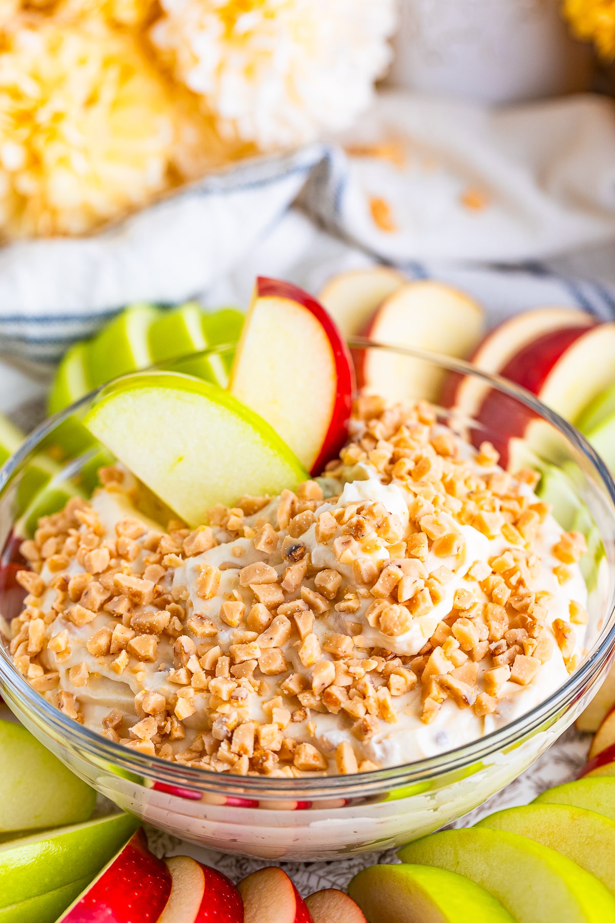 two apple slices in a bowl of Caramel Apple Dip