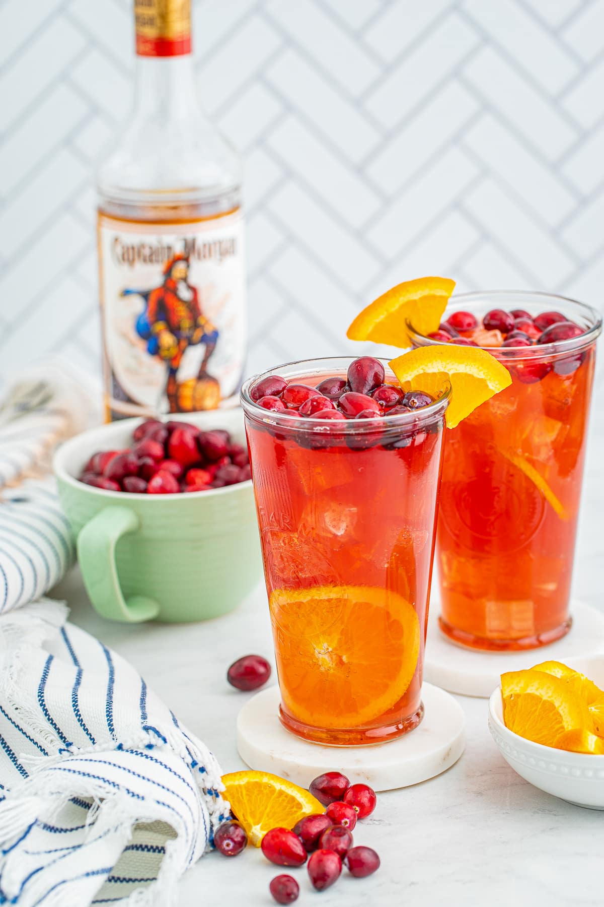 two glasses on marble coasters filled with Rum Punch