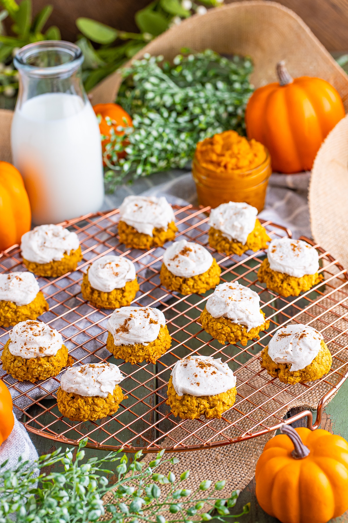 a bunch of Pumpkin Cookies with Oats on a wire rack sitting on green table top