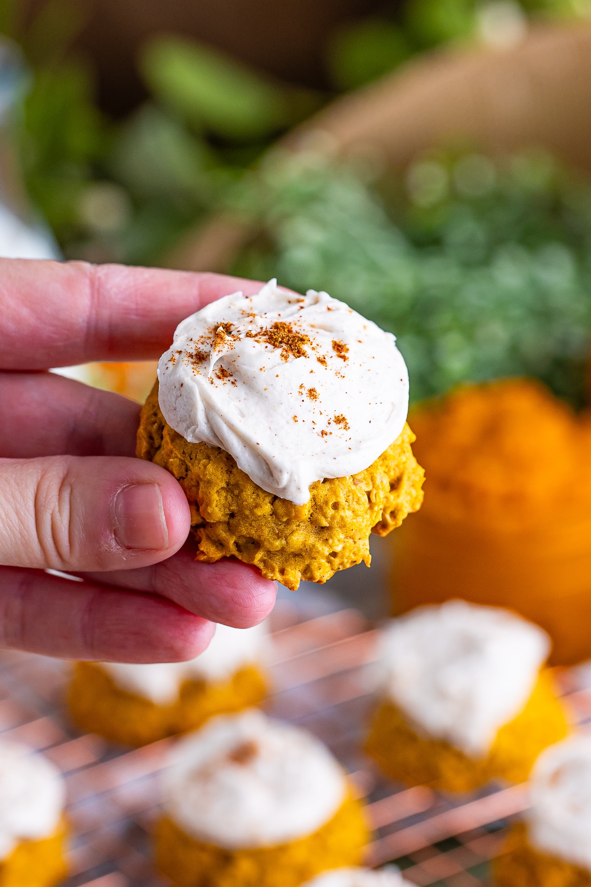 a hand holding up Pumpkin Cookies with Oats in air