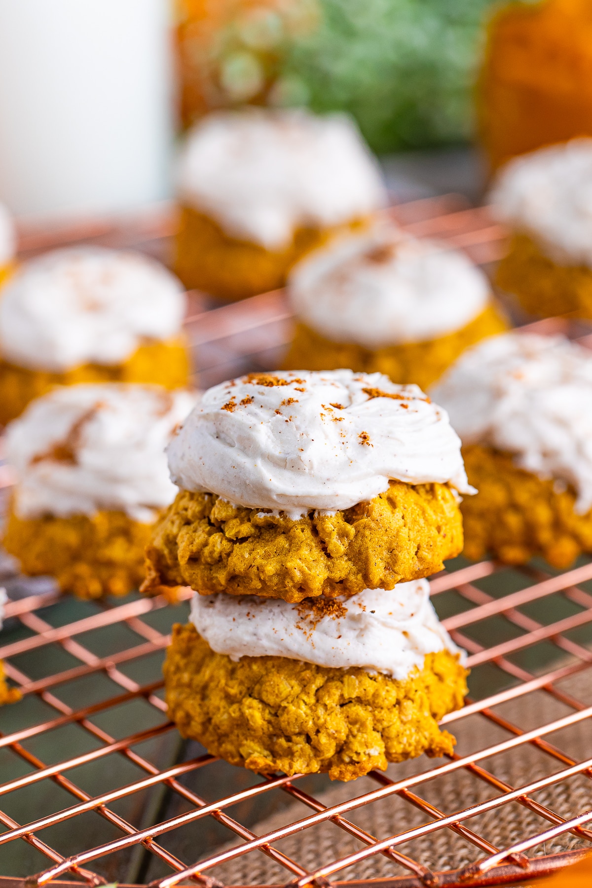 two Pumpkin Cookies with Oats stacked on top of each other on a wire rack