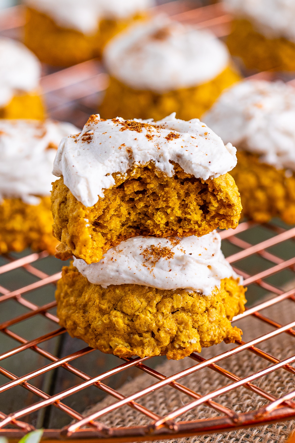 two Pumpkin Cookies with Oats stacked on top of each other, the one on top has a bite taken out