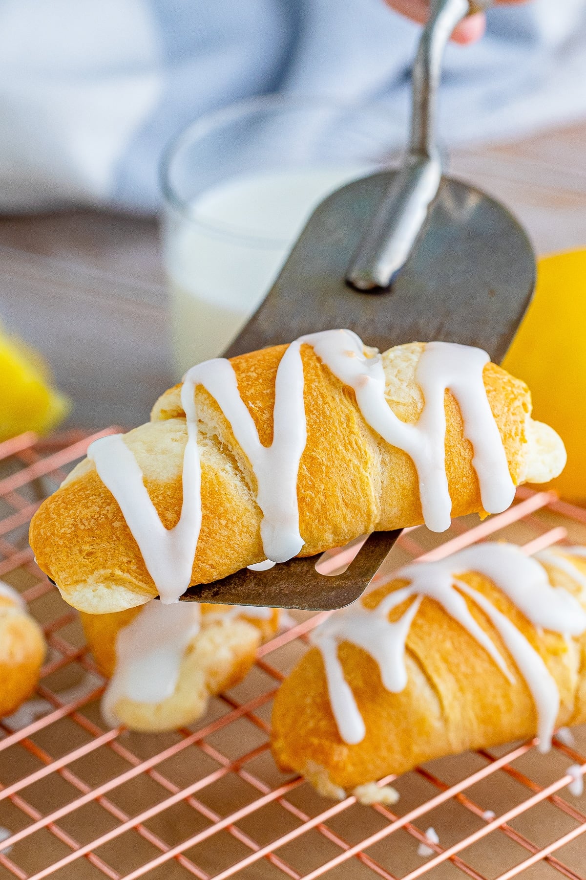 a spatula holding up Lemon Cheesecake Crescent Rolls in air