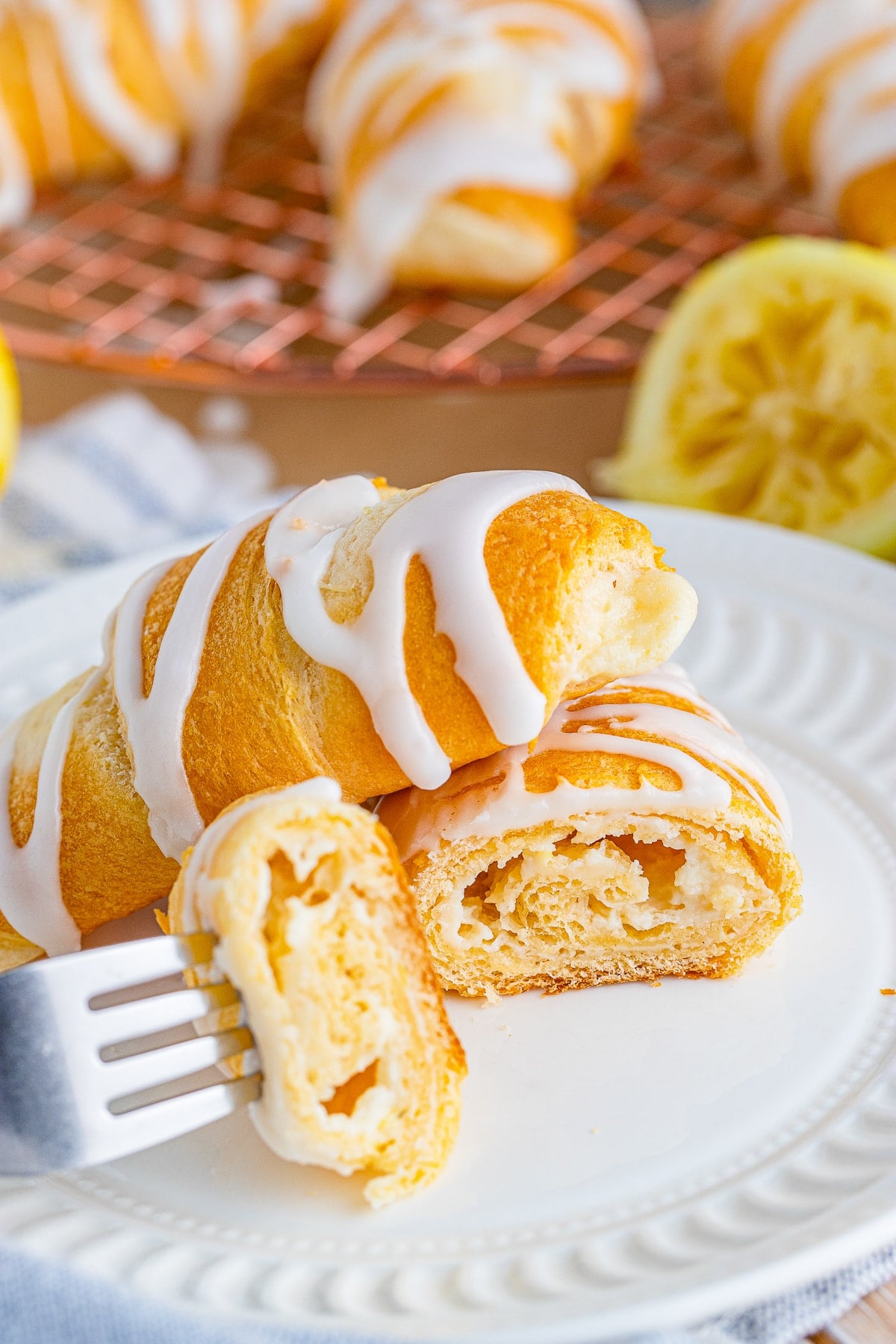 Lemon Cheesecake Crescent Rolls sliced in half on a white plate