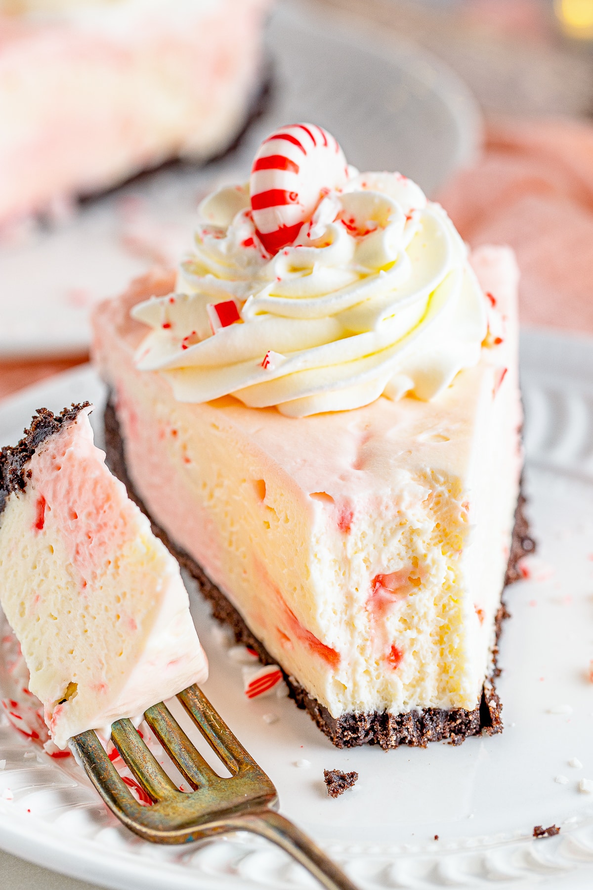 a slice of Peppermint Cheesecake on a plate with a bite taken out