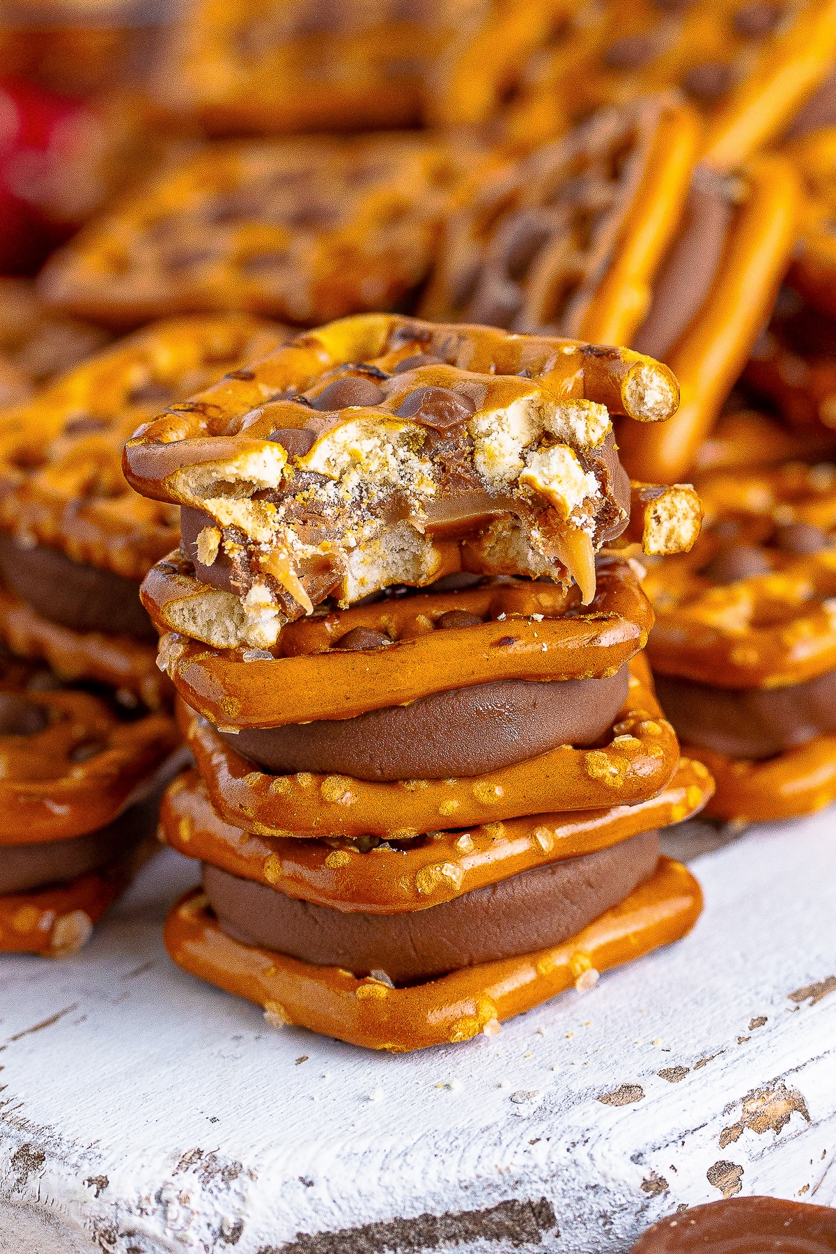 a stack of three Rolo Pretzel Recipe on top of each other, the one on top has a bite taken out