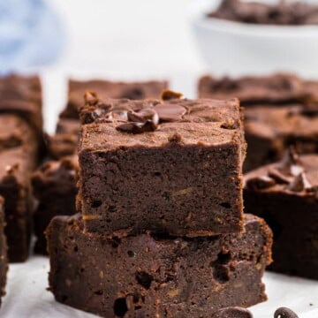 Fudgy sweet potato brownies cut into squares and stacked, showing a rich, dense center.